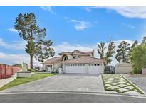 Expansive exterior showcasing desert landscaping and a large driveway leading to a spacious three-car garage at 3023 Paintedhills Ave, Las Vegas, NV 89120