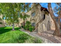 Charming apartment complex featuring stucco exterior, well-maintained landscaping, and mature trees at 5071 Pioneer Ave # 203, Las Vegas, NV 89146