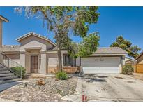 Charming single-story home featuring a two-car garage and low-maintenance desert landscaping at 5353 Dandelion Ct, North Las Vegas, NV 89031