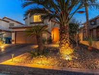 Charming two-story home featuring a well-manicured yard with lush landscaping and a welcoming entrance at 5779 Baffy Cir, Las Vegas, NV 89142