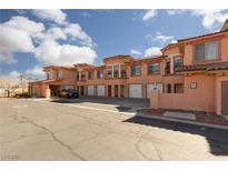 Charming townhome with multiple units, white garage doors and beautiful desert landscaping at 6 Via Vasari # 105, Henderson, NV 89011