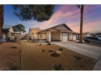 Charming single-story home with a two-car garage and desert landscaping at 6968 Royal Meadow Pl, Las Vegas, NV 89147