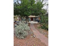 Charming home with lush greenery and a welcoming pathway to the entrance at 1812 Ivanhoe Way, Las Vegas, NV 89102