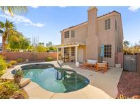 Outdoor pool and patio area with seating offer a relaxing backyard retreat at 262 Cielito Lindo St, Henderson, NV 89012