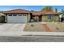Charming home featuring a red tile roof, desert landscaping, brick walkway and an attached two-car garage at 291 Lido Dr, Henderson, NV 89015