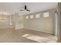 Bright living room with light wood floors, modern ceiling fan, and natural light from multiple windows at 4400 S Jones Blvd # 2103, Las Vegas, NV 89103