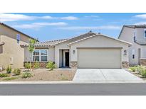 Inviting single-story home featuring a neutral color palette, well-manicured landscaping, and a spacious two-car garage at 442 Bridal Veil Falls St, Indian Springs, NV 89018