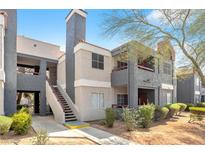 Well maintained condo exterior with stairs leading to the second floor and mature landscaping at 8600 W Charleston Blvd # 2078, Las Vegas, NV 89117