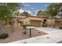Charming single-story home with a well-manicured front yard and attached two-car garage at 9533 Yucca Blossom Dr, Las Vegas, NV 89134