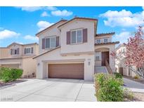 Charming two-story home featuring a large garage, neutral colors, manicured landscaping, and inviting front entrance at 10973 Sardinia Sands Dr, Las Vegas, NV 89141