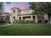 Charming two-story home with a well-manicured lawn and a cozy front porch seating area at 11334 Colinward Ave, Las Vegas, NV 89135