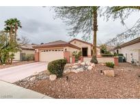 Charming single-story home with a two-car garage, desert landscaping, and a light-colored stucco exterior at 2007 High Mesa Dr, Henderson, NV 89012