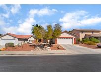Charming single-story home with a two-car garage and beautifully landscaped front yard at 208 Lynbrook St, Henderson, NV 89012
