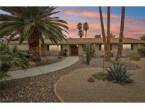 Charming single-story home with a desert landscape, palm trees, and a welcoming walkway to the front door at 3155 Duneville St, Las Vegas, NV 89146