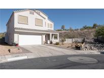 Charming two-story home with a two-car garage and a well-maintained front yard with desert landscaping at 3169 Crystal Moon Rd, Henderson, NV 89052