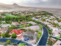 Expansive aerial view of a development area featuring homes and lake views, set against a backdrop of scenic mountains at 18 Placa De Rei Ct, Henderson, NV 89011