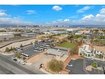 An aerial view of the property featuring buses, a playground and buildings against the Las Vegas skyline at 2130 E Maule Ave, Las Vegas, NV 89119
