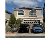 Two story home featuring a tile roof, two-car garage, and arched windows at 8116 Russell Creek Ct, Las Vegas, NV 89139