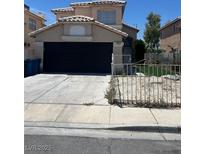 Two story home featuring a two car garage, a well kept lawn and neutral tan paint at 2211 Arborwood Way, Las Vegas, NV 89142