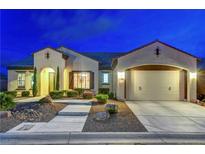 Charming single-story home featuring a well-manicured front yard and a two-car garage at 2913 Grande Arch St, Henderson, NV 89044