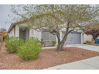 Charming single-story home with a well-maintained yard and desert landscaping at 5012 Naff Ridge Dr, Las Vegas, NV 89131