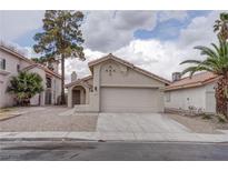 Single story home featuring stucco exterior, tile roof, desert landscaping, and an attached two car garage at 5328 Walton Heath Ave, Las Vegas, NV 89142