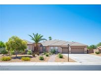 Charming single-story home featuring a tile roof, a three-car garage, and a beautifully landscaped front yard at 5815 Pristine Falls Ave, Las Vegas, NV 89131