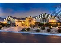 Charming home featuring a brick driveway, manicured landscaping, and elegant exterior lighting at 6373 Bridal Cave Ave, Las Vegas, NV 89131