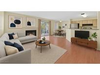Inviting living room with fireplace, neutral colors, and a sliding glass door with outside access at 7901 Idledale Ct # 102, Las Vegas, NV 89145