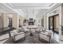 Bright living room with fireplace, high ceilings and elegant decor at 9 Greely Club Trl, Henderson, NV 89052