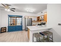 Bright kitchen features stainless steel appliances and a stylish island with seating at 5751 Hacienda Ave # 135, Las Vegas, NV 89122