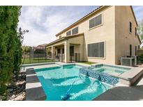 Inviting pool and spa with a -safe fence and turf area, perfect for outdoor enjoyment at 7416 Redhead Dr, North Las Vegas, NV 89084