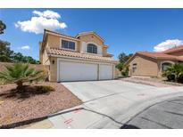 Inviting two-story home featuring a three-car garage and well-maintained front yard landscaping at 10021 Skipper Ct, Las Vegas, NV 89117
