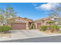 Charming single-story home featuring a three-car garage, terra cotta roof, and desert landscaping at 10024 Scenic Walk Ave, Las Vegas, NV 89149