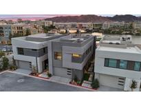 Stunning modern home with unique architecture and beautiful views of the water and mountains in the background at 16 Heron Harbour Dr, Henderson, NV 89011