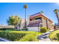 Charming two-story condo with a red tiled roof and balcony surrounded by lush greenery and palm trees at 3168 S Eastern Ave # 45, Las Vegas, NV 89169