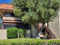 Two-story condo building with mature trees and landscaping, offering a welcoming curb appeal at 3168 S Eastern Ave # 45, Las Vegas, NV 89169
