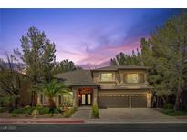 Beautiful two-story home with a three-car garage and manicured landscaping at 4156 Balmoral Castle Ct, Las Vegas, NV 89141
