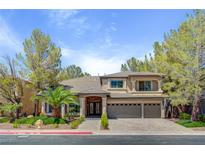 Beautiful two-story home with a three-car garage, landscaped front yard and elegant brick entryway at 4156 Balmoral Castle Ct, Las Vegas, NV 89141