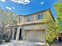 Inviting two-story home with a two car garage, landscaped front yard, and covered entryway at 8920 Appellation Ave, Las Vegas, NV 89148
