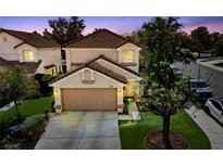 Charming two-story home with a well-manicured lawn, attached garage, and inviting curb appeal at 9409 Kayla Ct, Las Vegas, NV 89134