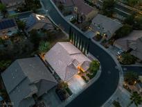Stunning aerial view of a home with a tile roof, desert landscaping, and a circular driveway on a quiet street at 1501 Via Salaria Ct, Henderson, NV 89052