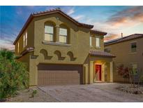 Inviting two-story home showcasing a well-maintained front yard and a two-car garage with a brick-paved driveway at 320 Point Loma Ave, North Las Vegas, NV 89031