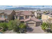 Stunning two-story home with a well-manicured lawn, mature trees, and a three-car garage at 1212 Equator Ave, North Las Vegas, NV 89032