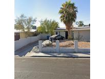 Charming single-story home with mature landscaping, and a concrete fence at 1804 David Ave, Las Vegas, NV 89101