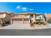 Lovely two-story home featuring a three-car garage, mature landscaping, and an eye-pleasing terracotta-colored roof at 3921 White Castle St, Las Vegas, NV 89129