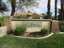 Community entrance sign featuring stone pillars and lush landscaping at 5038 S Rainbow Blvd # 206, Las Vegas, NV 89118