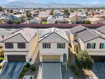 Two-story stucco home with a tile roof, two car garage, and desert landscaping at 5667 Foxglove Field St, Las Vegas, NV 89130