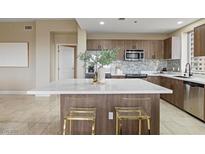 Modern kitchen boasts a large island, stainless appliances, and stylish backsplash at 8255 Las Vegas Blvd # 802, Las Vegas, NV 89123