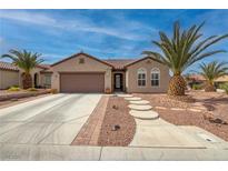 Charming home featuring beautiful desert landscaping, a two-car garage, and a stylish, tiled roof at 2217 Merrimack Valley Ave, Henderson, NV 89044